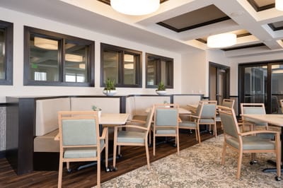 Cozy common area with seating and windows.