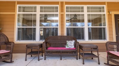 Outdoor seating area with wicker chairs.