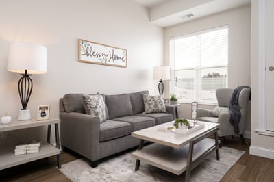Cozy living room with soft furnishings and decor.
