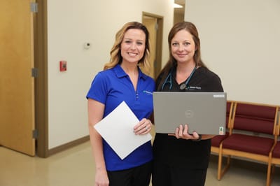 Two healthcare professionals smiling together