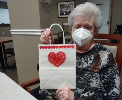 Resident displaying a decorated gift bag.