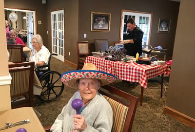 Residents enjoying a festive activity in a common area.