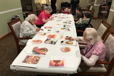 Residents engaged in an art activity together.