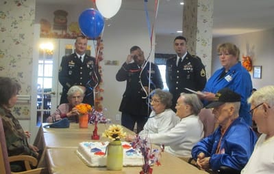 Residents celebrating a milestone with cake and decorations.
