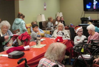 Residents engaged in a festive activity in a common area.