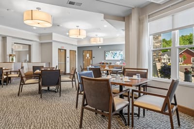 Dining area with tables and chairs for residents.
