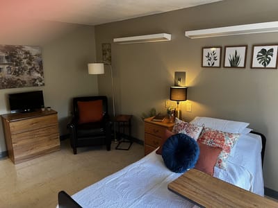 A cozy private resident room with a bed and decor