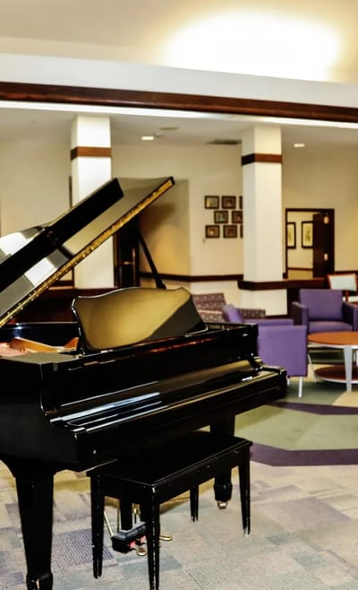 A grand piano in a common area of the facility