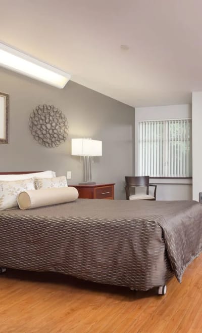Private resident room with bed and chair