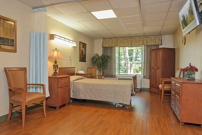 A cozy resident room with a bed and furniture