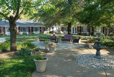 Outdoor seating area with garden features and fountain