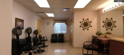 Beauty salon area with styling chairs and mirrors