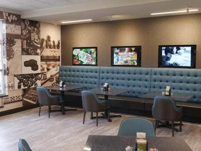 Interior dining area with seating and screens