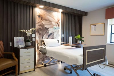 A serene patient room with floral decor and medical equipment
