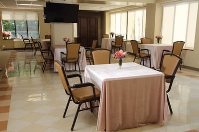 Bright dining room with tables and flowers