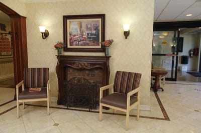 Common area with decorative fireplace and chairs