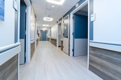 A clean and modern hallway in a nursing facility
