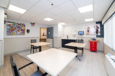 Bright interior common area with tables and artwork