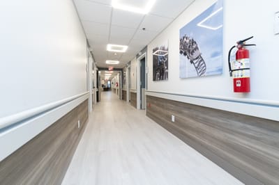 Brightly lit hallway with artwork on the walls