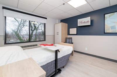 A cozy resident room with a view and simple decor