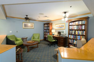 Cozy library area with comfortable seating and bookshelves