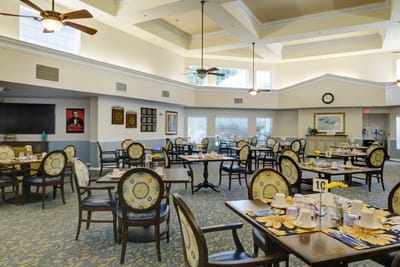 Bright dining room with neatly set tables and chairs
