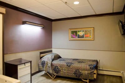 Cozy resident room with a single bed and artwork