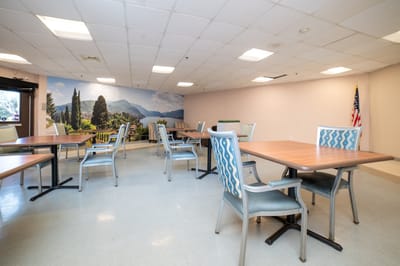 Bright interior with dining tables and a mural