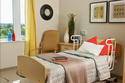 Cozy resident room with bed and chair