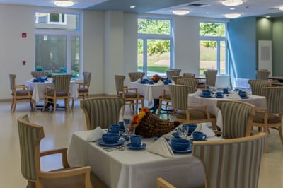 Bright dining room with tables set for a meal
