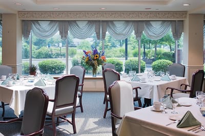 Dining room with elegant table settings and flowers
