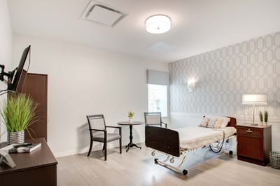 Private resident room with a bed and seating area