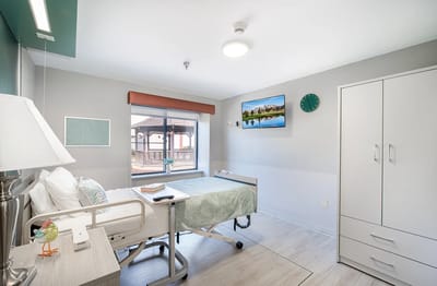 A private resident room with a bed and window