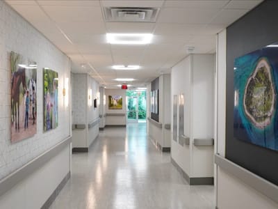 Bright, well-lit hallway with art on the walls