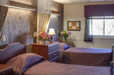 A cozy interior of a shared resident room with floral decor