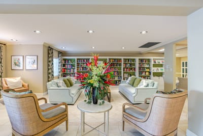 Bright common area with comfortable seating and bookshelves