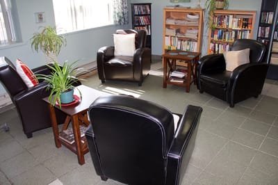 Cozy common area with seating and bookshelves