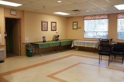 Bright common area with tables and chairs.