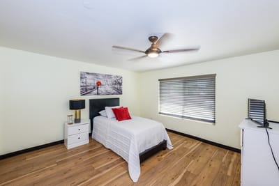 A cozy, well-decorated resident room with a bed and window