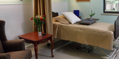 Cozy resident room with flowers and a bed