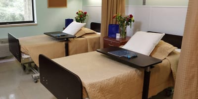 Resident room with beds and flowers
