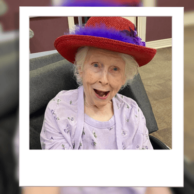 Smiling elderly woman in a colorful hat