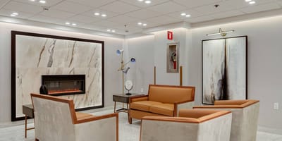 Modern lounge area with seating and fireplace.