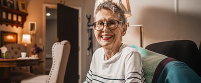 Smiling elderly woman in a comfortable living space
