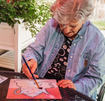 Senior woman painting outdoors