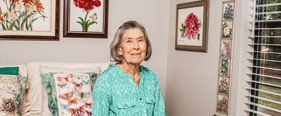Elderly woman smiling in a decorative room