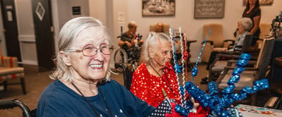Residents engaging in a crafting activity indoors.