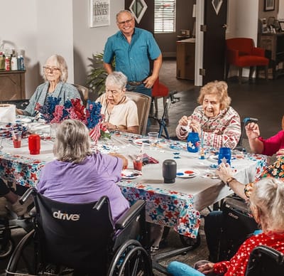 Residents engaging in a crafting activity at a table.