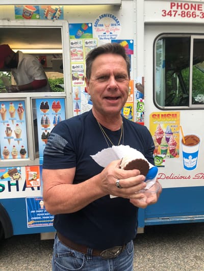 Man enjoying an ice cream treat outdoors.