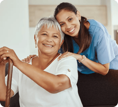 Resident and staff member smiling together